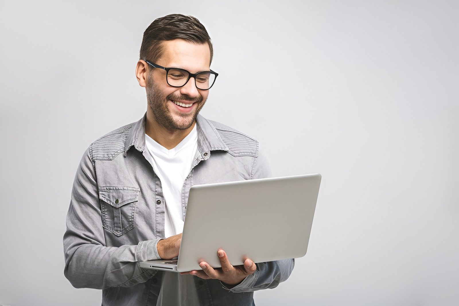 Smiling customer holding a laptop, ready to activate genuine Microsoft software